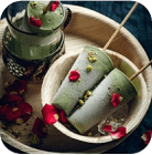 two green cups in a wooden bowl